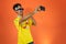 Brazilian Player- Black Man Celebrating With Yellow T Shirt Isolated on Orange background