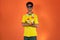 Brazilian Player- Black Man Celebrating With Yellow T Shirt Isolated on Orange background