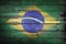 Brazilian rustic, vintage and weathered flag painted on wooden wall.