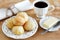 Brazilian snack pao de queijo (cheese bread) white plate butter