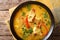 Brazilian stew fish with vegetables and coconut milk close-up in