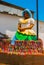 Brazilian woman of African descent, smiling, dressed in traditional Baiana attire in Pelourinho, Salvador, Brazil