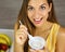 Brazilian woman eating light yogurt at home. Close up from above. Healthy concept