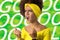 Brazilian woman fan celebrating on football match on white background. Brazil colors.