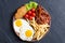 Breackfast : french fries , bacon and fried eggs