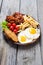 Breackfast : french fries , bacon and fried eggs