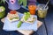 Bread with avocado, tomatoes and cheese on a blue towel and a board. Sandwiches for breakfast and juice. A healthy diet for a diet