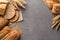 Bread background with wheat, aromatic crispbread with grains, copy space, top view. Brown and white whole grain loaves still life