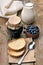 Bread, blueberry jam and milk on wooden table