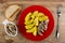 Bread, bowl with fish, plate with pieces of canned herring and fried potato, fork on table. Top view