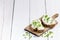 Bread with butter and spread. Concept of healthy breakfast. Spring onion, Vegetables. Wooden white table with copy space