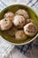 Bread dumplings with broth, close-up on the table. vertical top