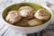 Bread dumplings canederli in a broth close up. horizontal