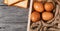 bread and eggs is in paper trays put on wooden floor background