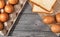 bread and eggs is in paper trays put on wooden floor background