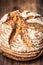 Bread.Fresh round crisp bread with caraway on wooden table