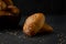 Bread, freshly baked on black background. Piles of breads. Bakery of breads.