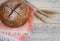 Bread with home-baked cereals on a light napkin with spikelets, white wooden background.