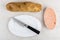 Bread, knife in dish, herring caviar with mayonnaise in jar