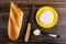 Bread, knife, sandwich with krill paste in saucer, spoon with paste on wooden table. Top view