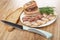 Bread, knife, slices of salted pork lard, piece of lard, dill in plate on wooden table