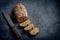 Bread loaf sliced on dark background