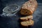 Bread loaf sliced on dark background