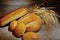 Bread, loaf, white bread, wheat ears on a background of burlap