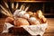 Bread and lots of fresh bread buns in a basket on a wooden table