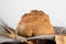 The bread of Matera, Pane di Matera on linen napkin on white wooden background, typical southen italian sourdough bread