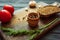 Bread, mixture of peppers, garlic, herbs and tomatoes on a brown board 1