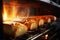 Bread in the oven at a bakery. Production and baking of fresh bread. Industrial furnace. Baking bread. Fire, smoke and steam.