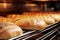 Bread in the oven at a bakery. Production and baking of fresh bread. Industrial furnace. Baking bread. Fire, smoke and steam.