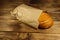 Bread packed in paper on wooden table