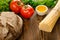 Bread with pasta, tomatos, greens, oil and pepper on wood