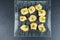 Bread pieces with delicious cod caviar on black stone slate background