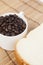 Bread plate and cup with coffee beans.