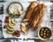 Bread with polenta on a rustic table with avocado, cherry tomatoess, green olives and cream cheese