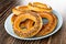 Bread rings baranka with poppy seeds in blue plate on wooden table