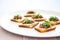 bread slices with tapenade spread on white plate