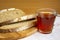 Bread and tea. Slices of bread and a glass of strong tea close-up. Fresh aromatic rye bread, cut into pieces