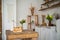 Bread in a textured wooden box in the kitchen in a rustic style. Breakfast, bread, white cups in the interior of bright Scandinavi