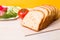 bread for toast with slices of vegetables lies on a wooden cutting board