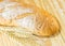 The bread and wheat on the wood background, warm toning