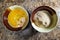 Breadcrumbs and chicken yolk in bowls on table