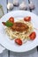 Breaded carp fillet with tomato on pasta