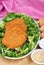 Breaded cutlet with some salad on a plate