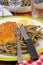 Breaded escalope with green beans and a slice of lemon served on a plate