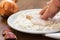 Breading of raw chicken. Hand pushing into flour with spices. close up shot. onion garlic