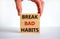 Break bad habits symbol. Wooden blocks with words `break bad habits`. Male hand. Beautiful white background, copy space. Busines